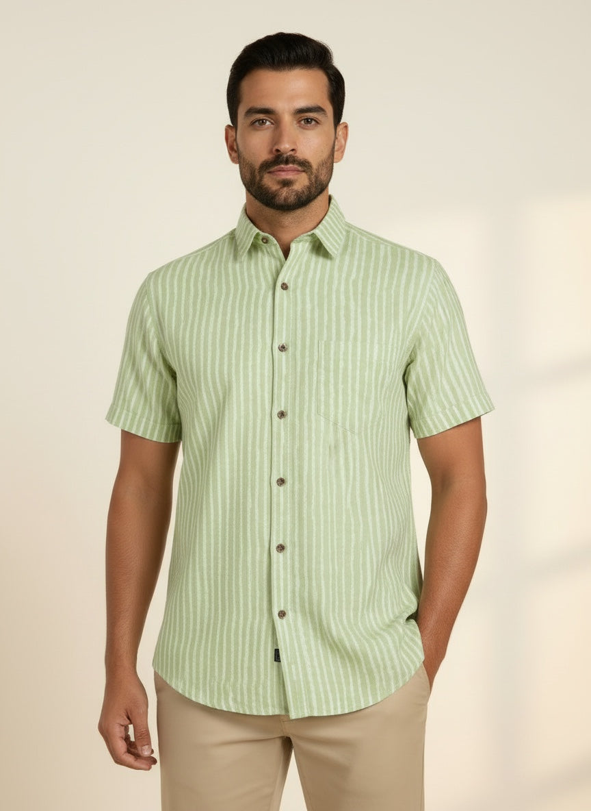 Faboriq sage green short-sleeve cotton shirt with white vertical stripes, point collar, and wooden buttons on a model